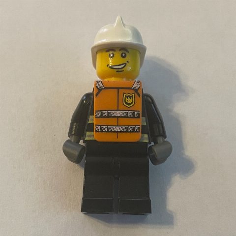 Minifigurka Fireman, Black Fire Jacket with Reflective Stripes, Radio, and Badge, White Helmet, Orange Vest
