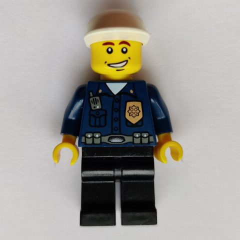 Minifigurka Policeman, Dark Blue Shirt with Radio and Badge, Black Legs, Black Cap, Smile